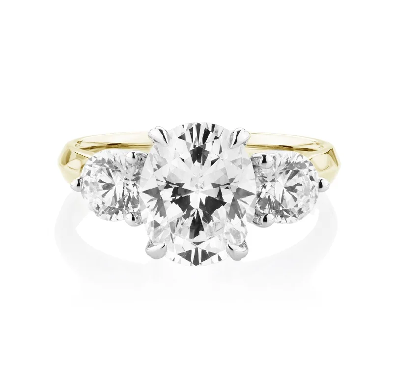 Elegant Wedding Rings-Three stone ring with 3.46 carats* of diamond simulants in 10 carat yellow and white gold