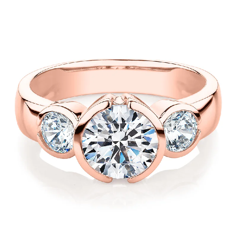 Modern Diamond Engagement Rings-Three stone ring with 2.23 carats* of diamond simulants in 10 carat rose gold