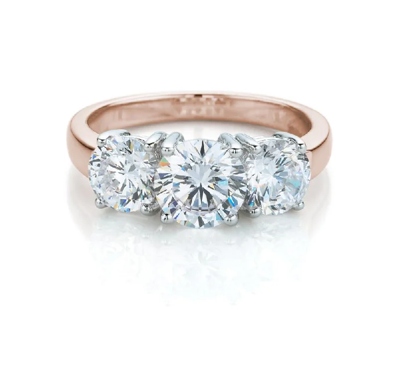 Oval Diamond Rings-Three stone ring with 2 carats* of diamond simulants in 10 carat rose and white gold